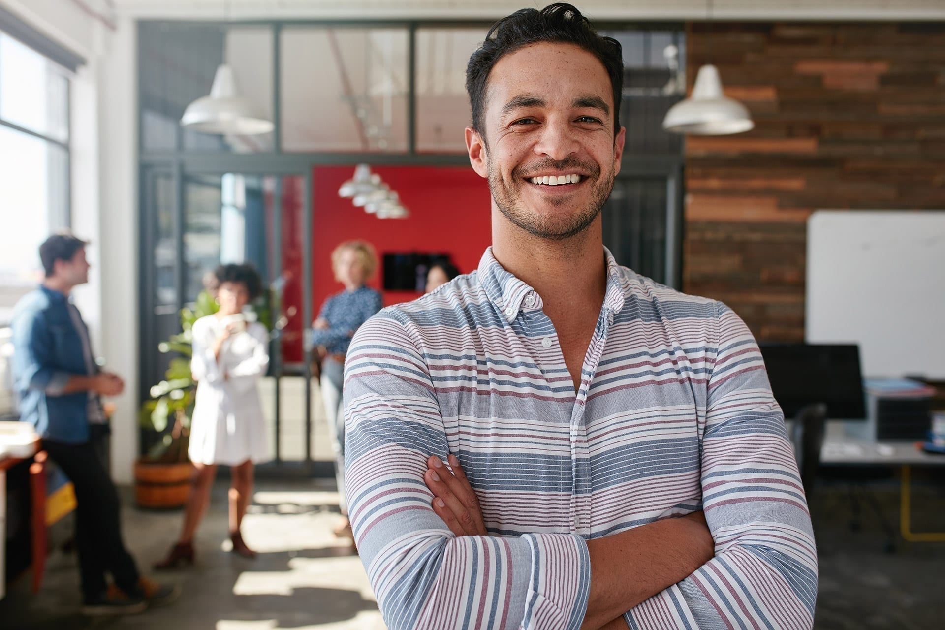 Smart male designer happy about the results that Office Technology Partners got for his company