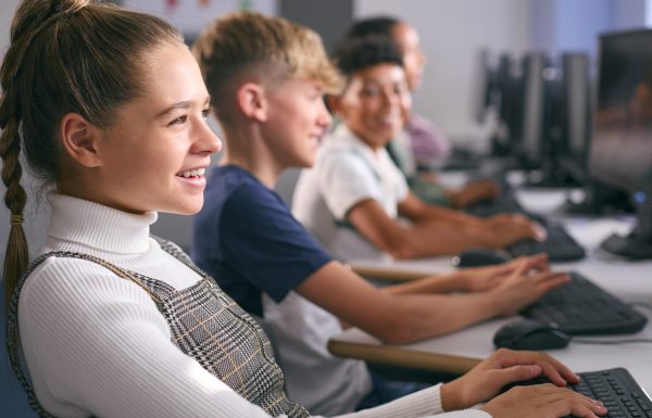 Multi-Cultural Group Of Secondary Or High School Students At Computers In IT Class